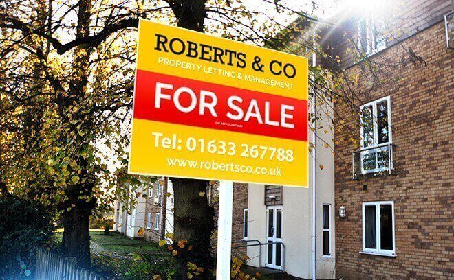 red and yellow estate agent for sale sign on a correx board