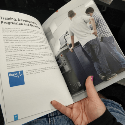 employee handbook open on a page about training and development